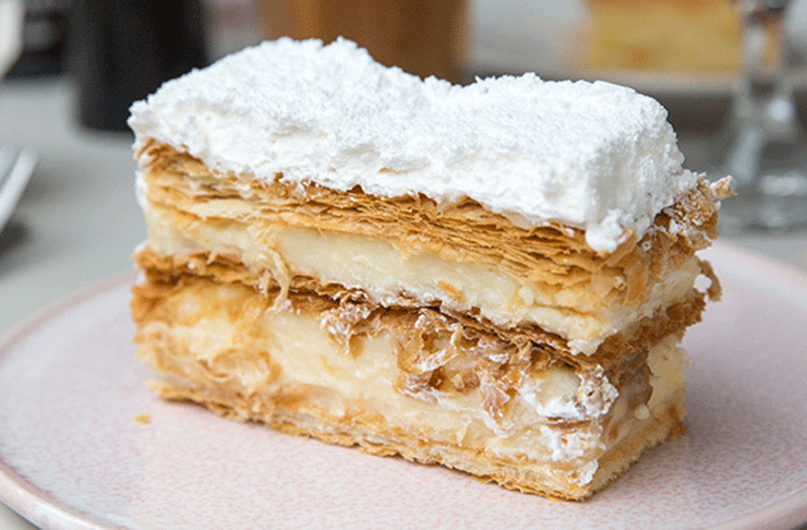 A delicious mille-feuille with flakey pastry, filled with custard and topped with white icing.